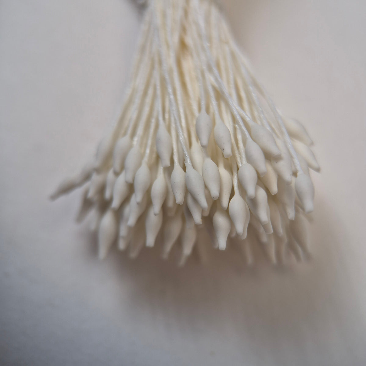 Cream elongated flower stamens size M on matching cream cotton threads, premium Japanese floral supplies