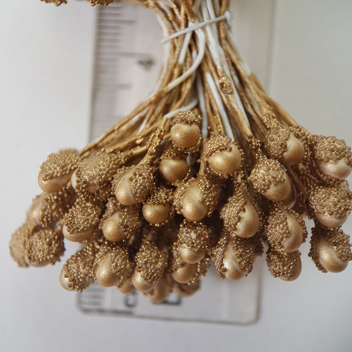 A bundle of extra-large size XL textured Japanese flower stamens, featuring rich antique gold droplet-shaped heads decorated with shimmering gold microbeads