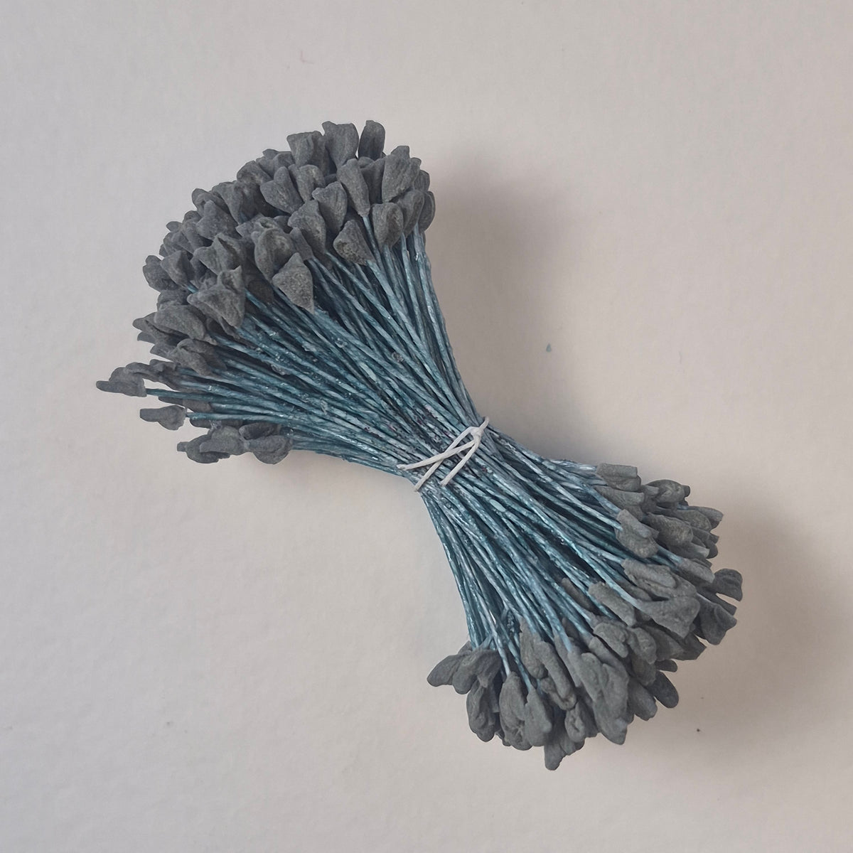 A bundle of extra-large size XL naturalistic Japanese flower stamens, featuring subtle grey droplet-shaped heads on contrasting light blue rayon threads
