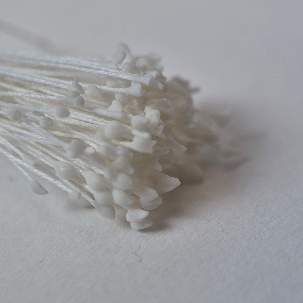 Miniature white naturalistic flower stamens size S with botanical shapes on white cotton threads, premium Japanese craft supplies