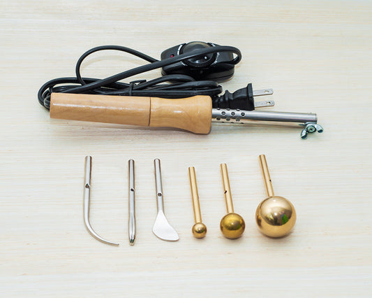 Soldering iron with various attachments on a light background