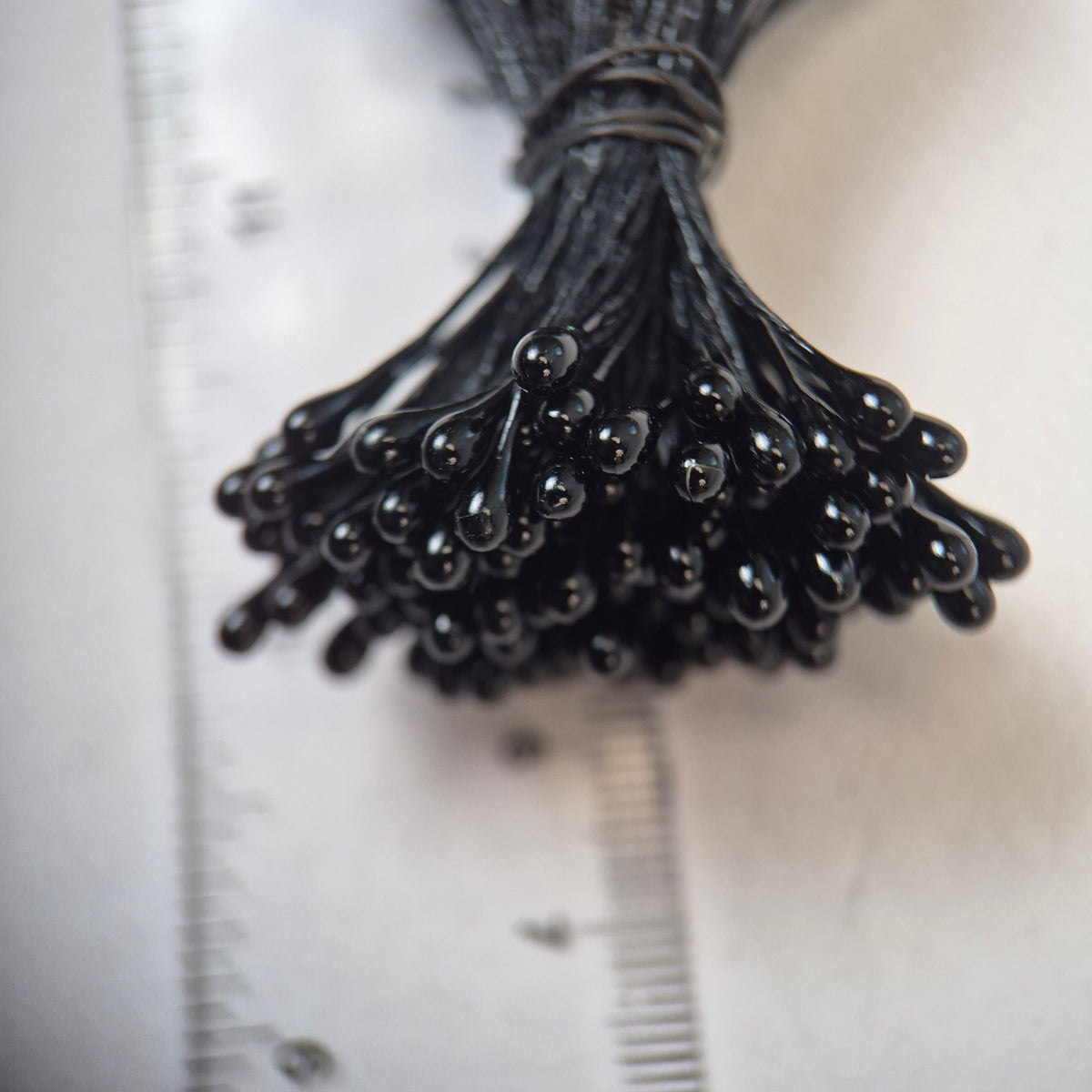 Black pearl flower stamens size L with glossy finish on matching black cotton threads, bundle of 144 pieces, premium Japanese floral supplies