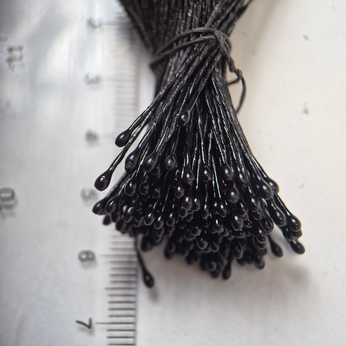 Black pearl flower stamens size L with glossy finish on matching black cotton threads, bundle of 144 pieces, premium Japanese floral supplies