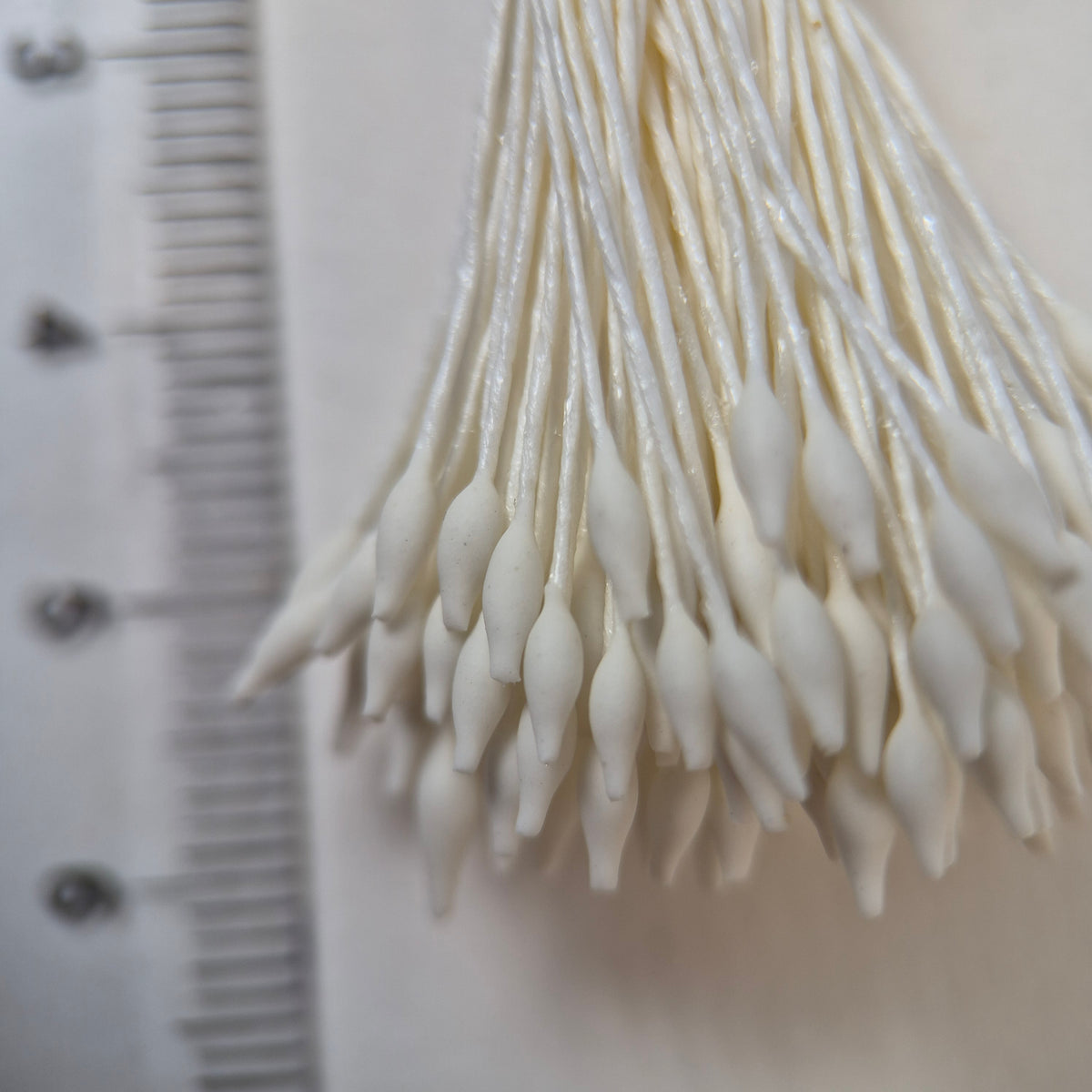 Cream elongated flower stamens size M on matching cream cotton threads, premium Japanese floral supplies