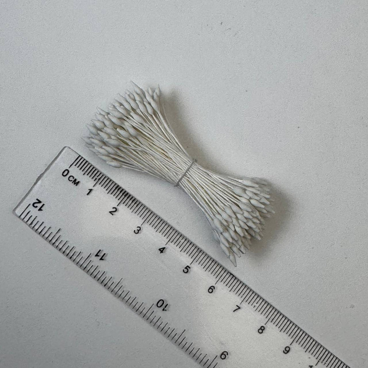 Cream elongated flower stamens size M on matching cream cotton threads, premium Japanese floral supplies