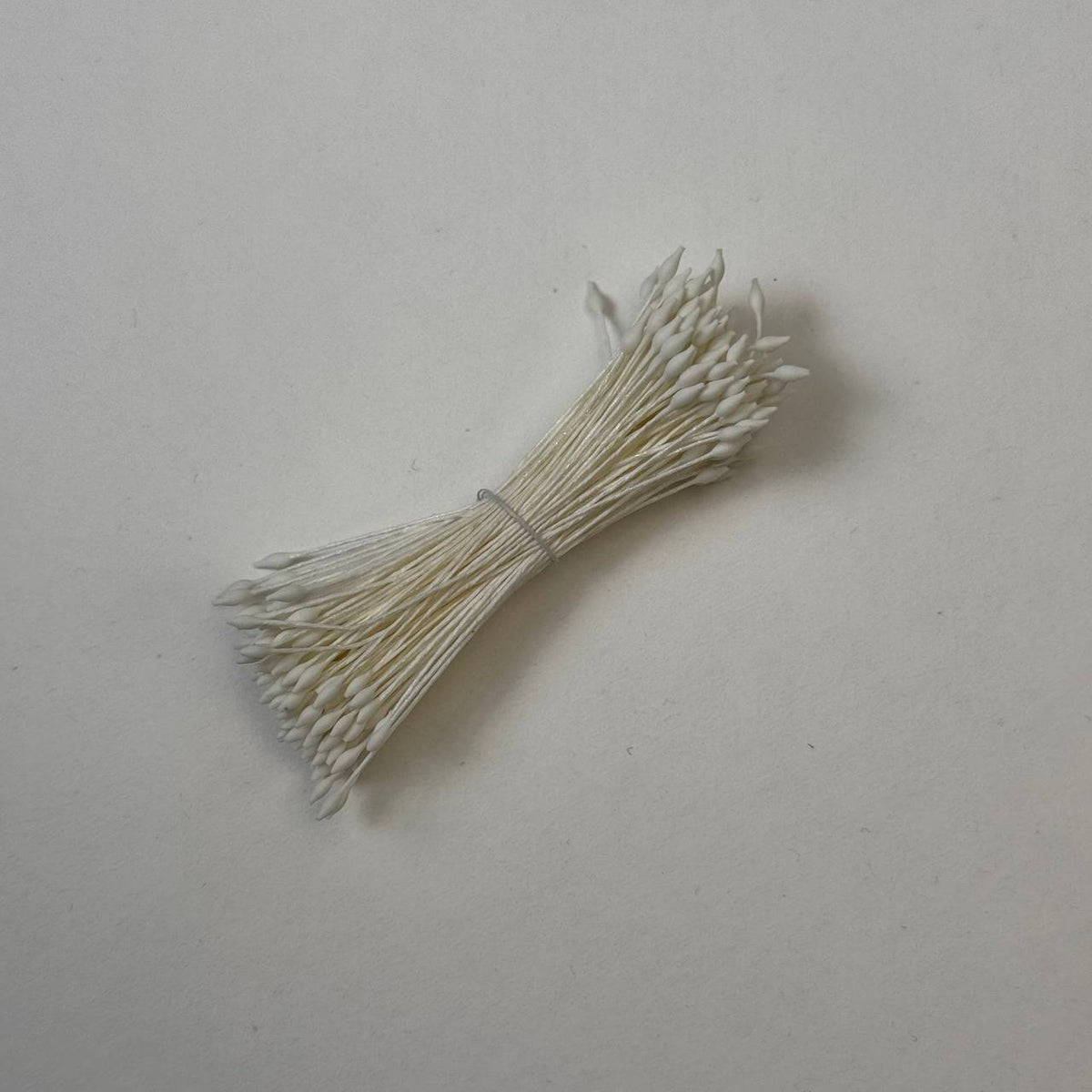 Miniature cream elongated flower stamens size S on matching cream cotton threads, premium Japanese floral supplies