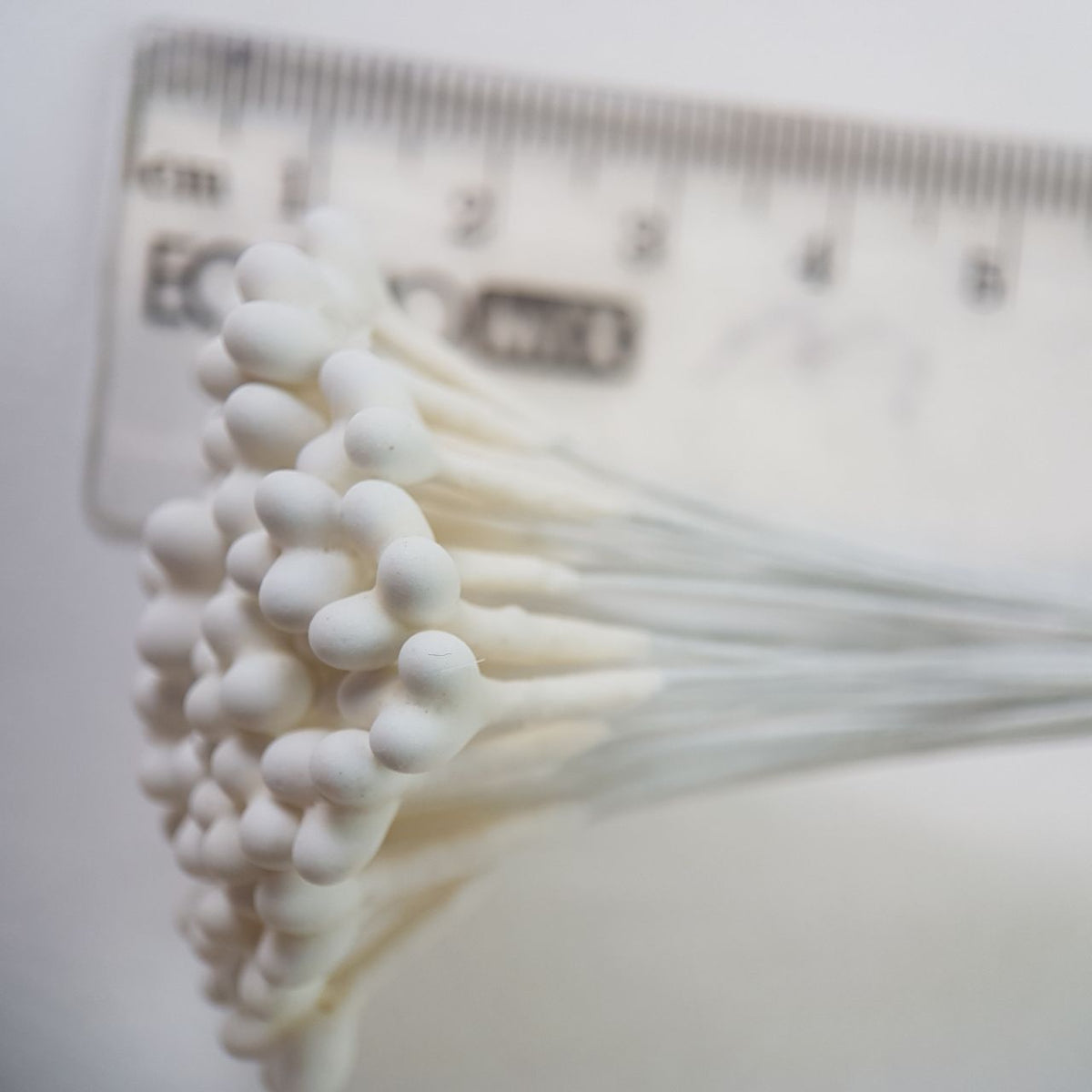 A bundle of 36 single-sided white decorative Japanese stamens on flexible 13cm white wire stems, featuring large heads with three droplets fused into a single stamen
