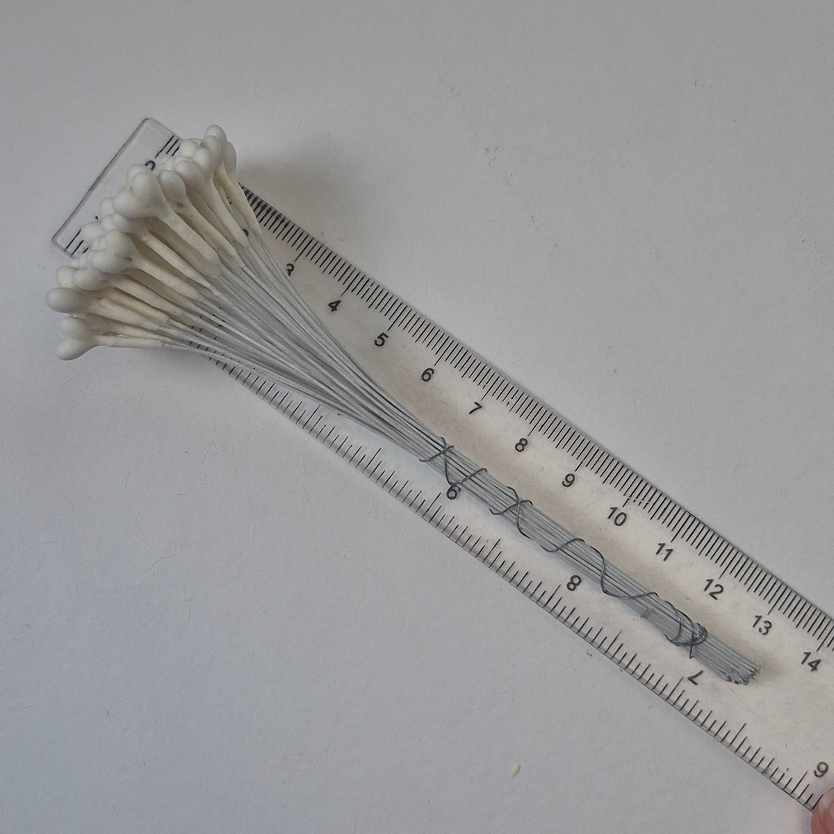 A bundle of 36 single-sided white decorative Japanese stamens on flexible 13cm white wire stems, featuring large heads with three droplets fused into a single stamen