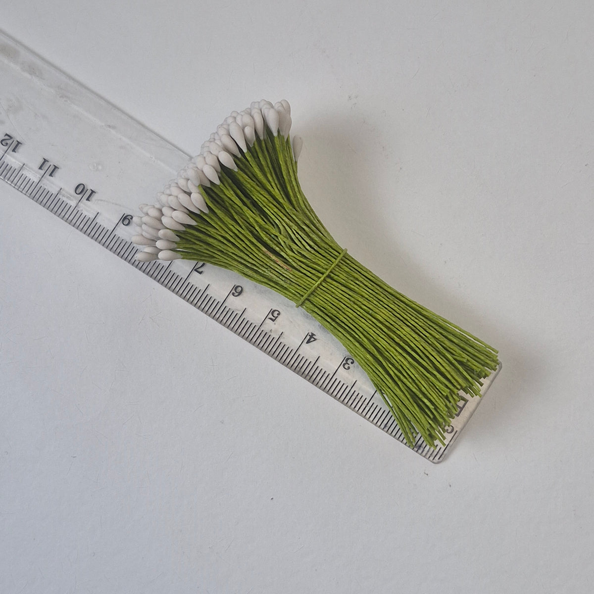 A bundle of 144 single-sided white round decorative Japanese flower stamens on flexible 8cm green wire stems