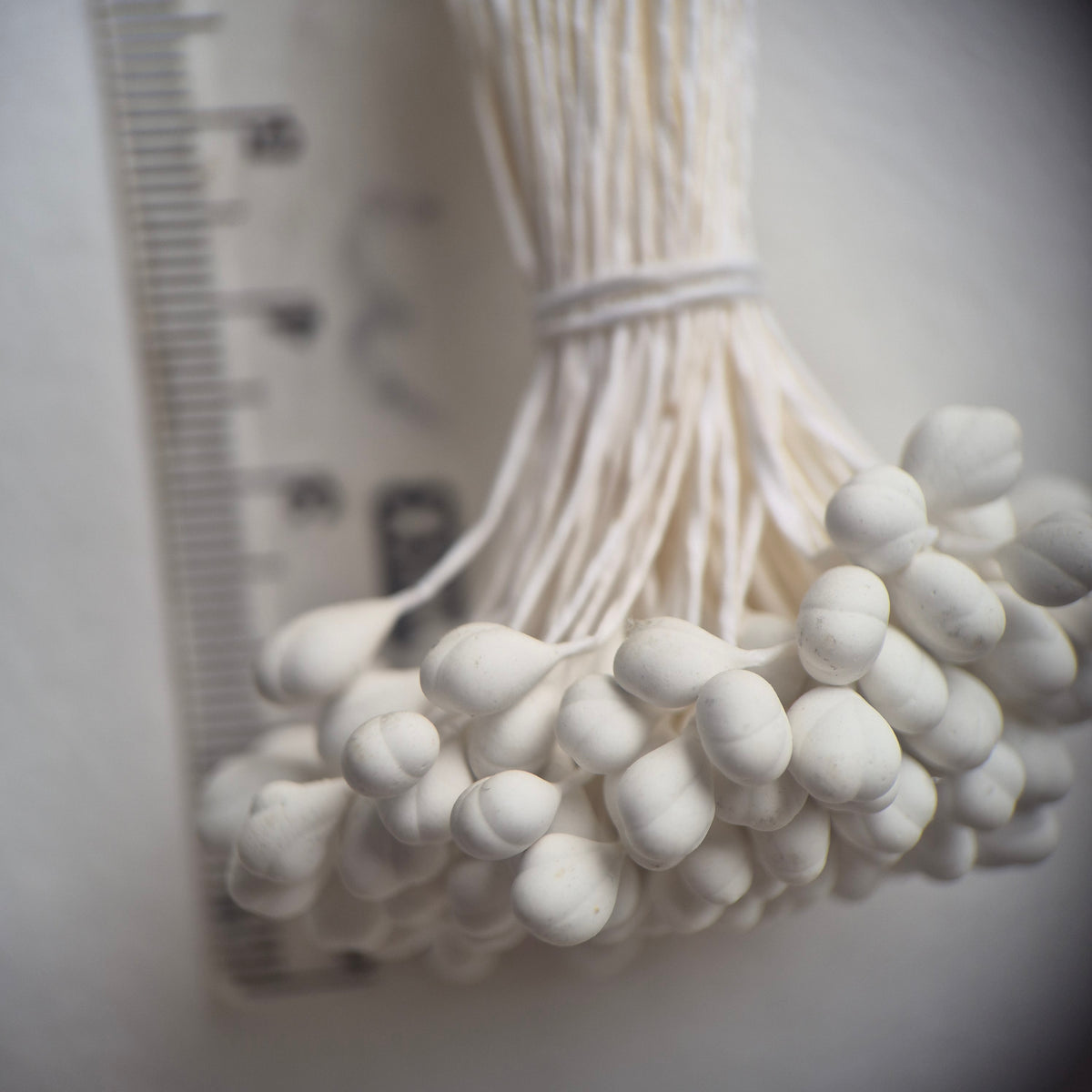 A bundle of 144 single-sided white decorative Japanese flower stamens/buds on high-quality white threads, featuring smooth droplet-shaped heads