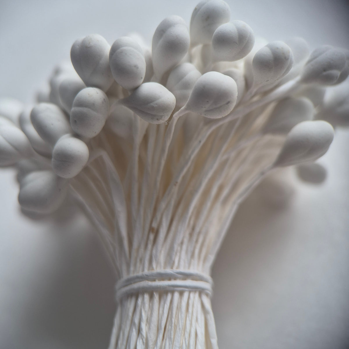 A bundle of 144 single-sided white decorative Japanese flower stamens/buds on high-quality white threads, featuring smooth droplet-shaped heads