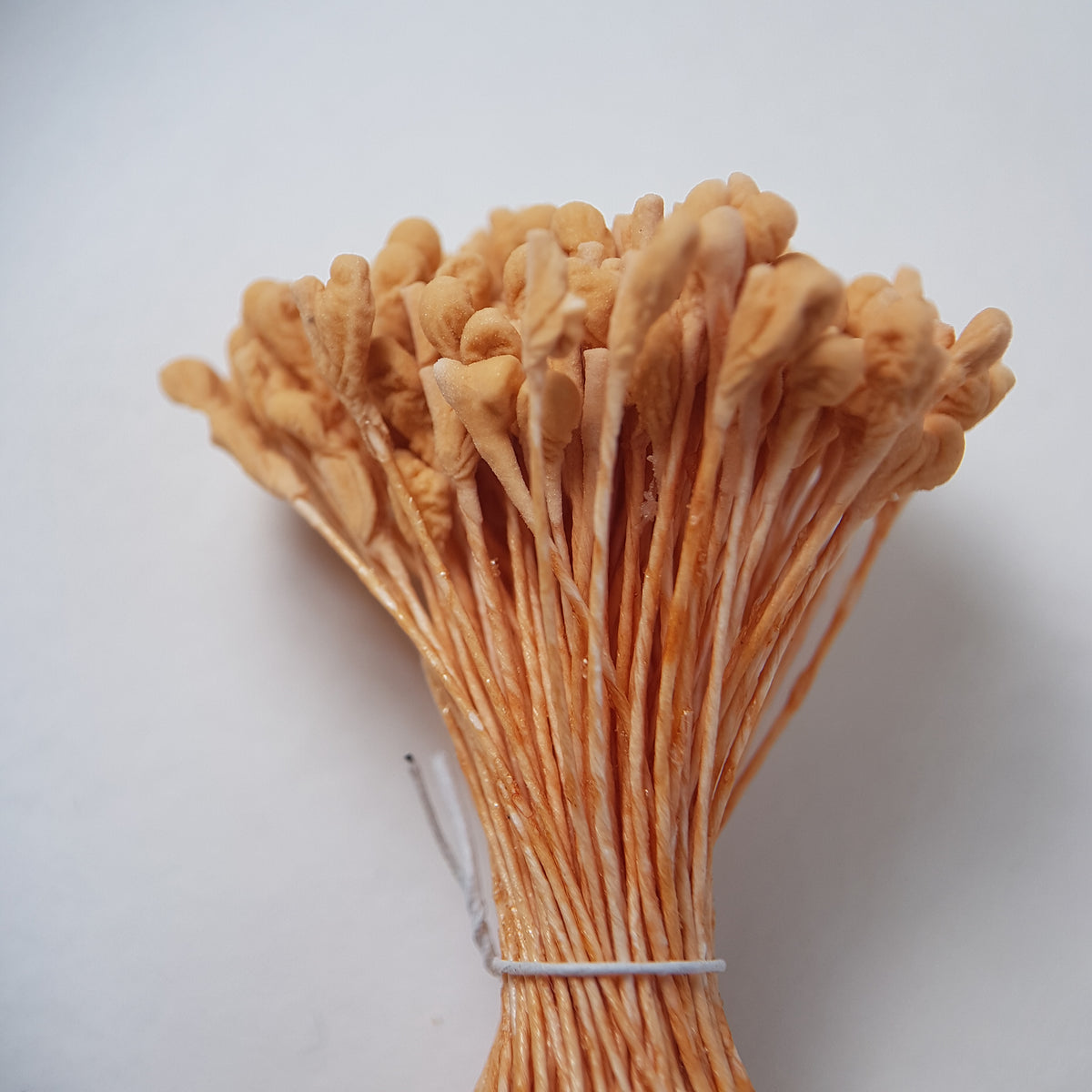 A bundle of extra-large size XL naturalistic Japanese flower stamens, featuring soft beige droplet-shaped heads on matching beige rayon threads