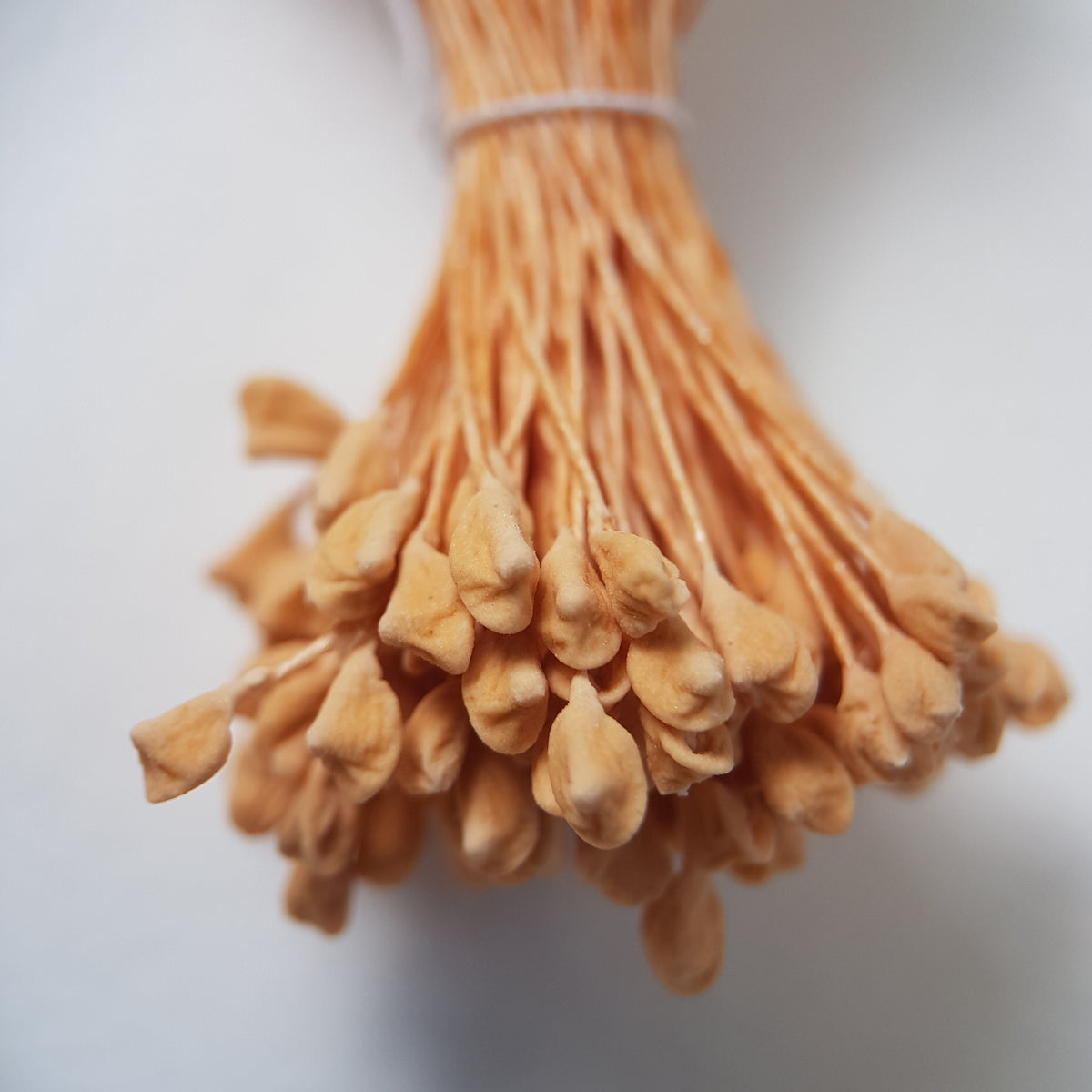 A bundle of extra-large size XL naturalistic Japanese flower stamens, featuring soft beige droplet-shaped heads on matching beige rayon threads