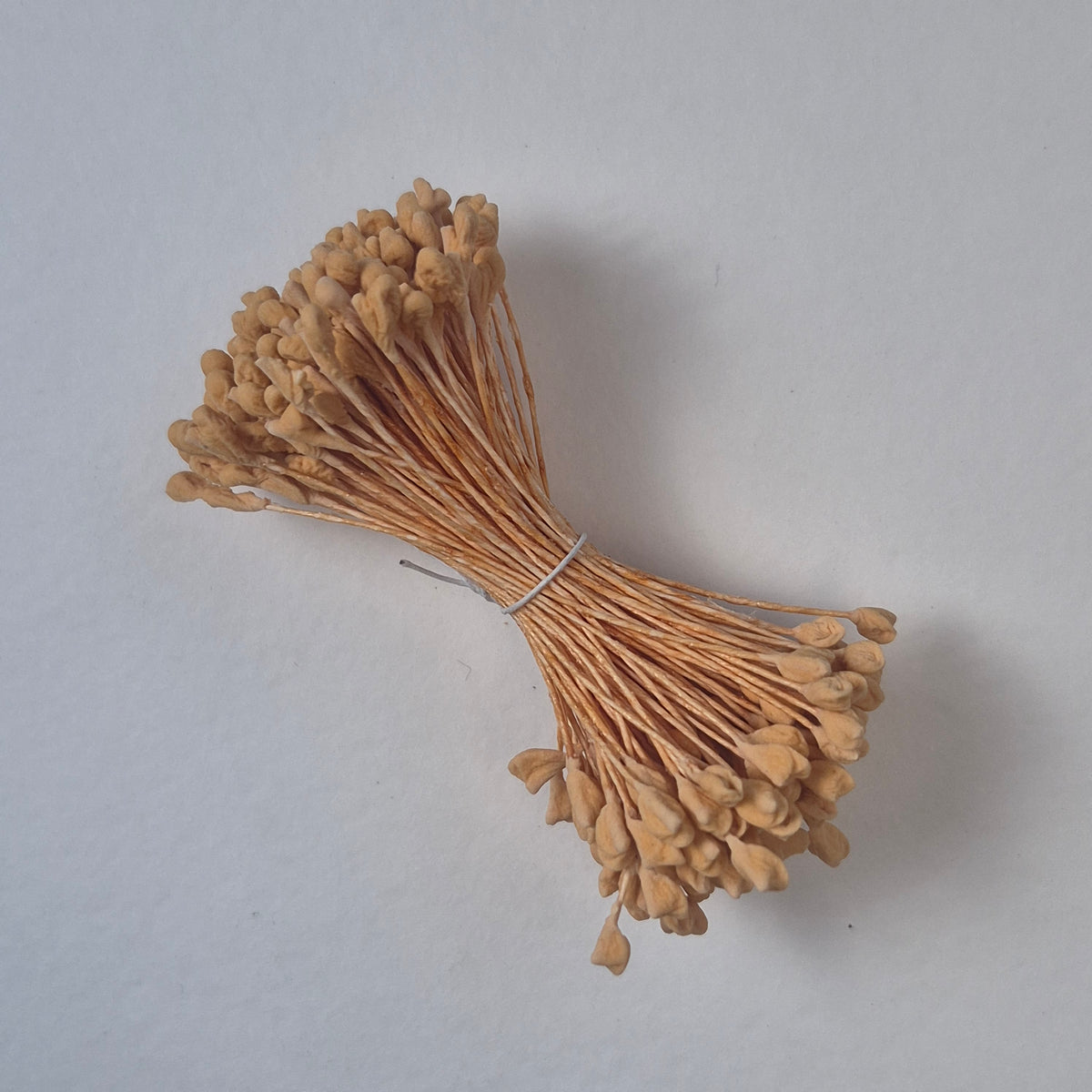 A bundle of extra-large size XL naturalistic Japanese flower stamens, featuring soft beige droplet-shaped heads on matching beige rayon threads
