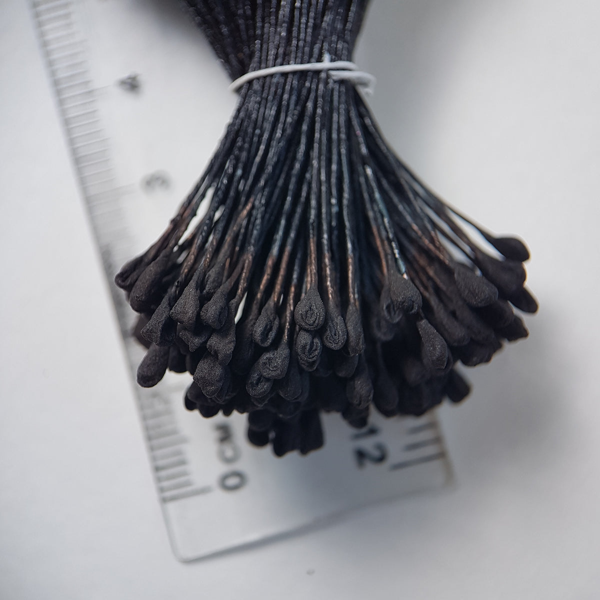 A bundle of extra-large size XL naturalistic Japanese flower stamens, featuring classic black droplet-shaped heads on matching black rayon threads