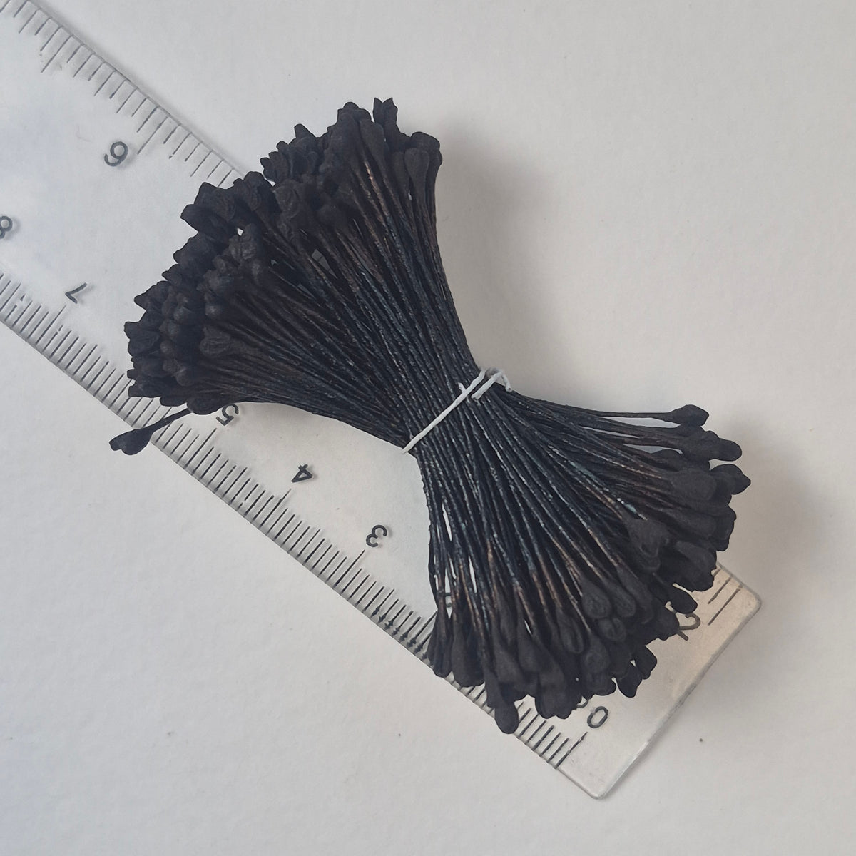 A bundle of extra-large size XL naturalistic Japanese flower stamens, featuring classic black droplet-shaped heads on matching black rayon threads