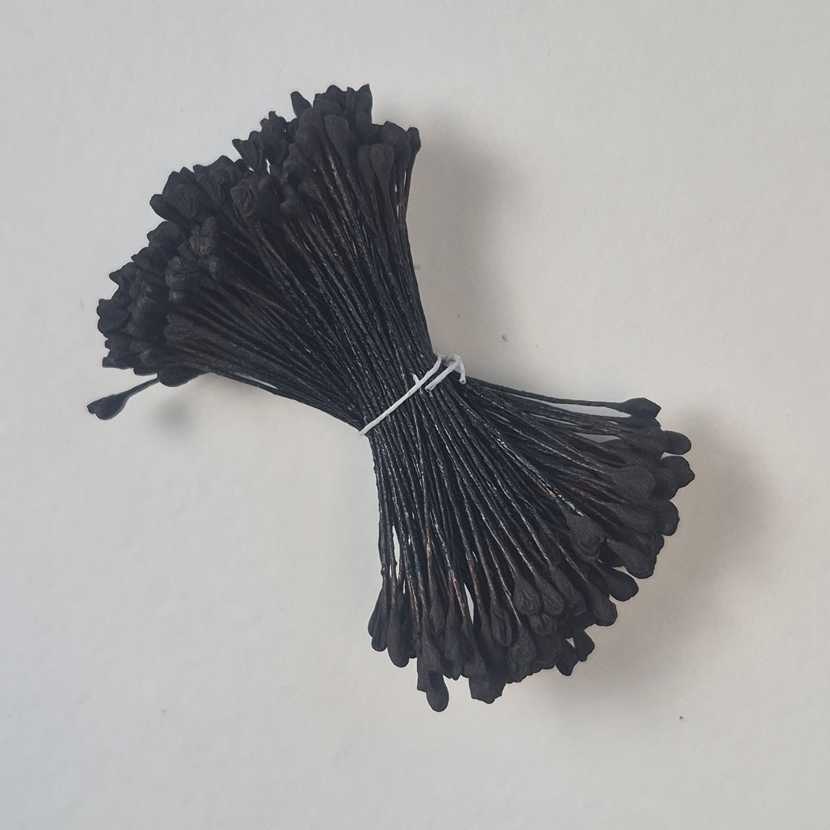 A bundle of extra-large size XL naturalistic Japanese flower stamens, featuring classic black droplet-shaped heads on matching black rayon threads