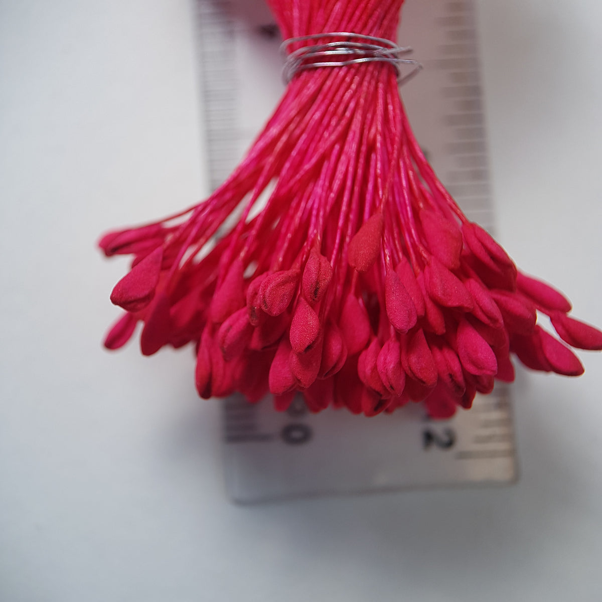 A bundle of extra-large size XL naturalistic Japanese flower stamens, featuring vibrant bright pink droplet-shaped heads on matching pink rayon threads