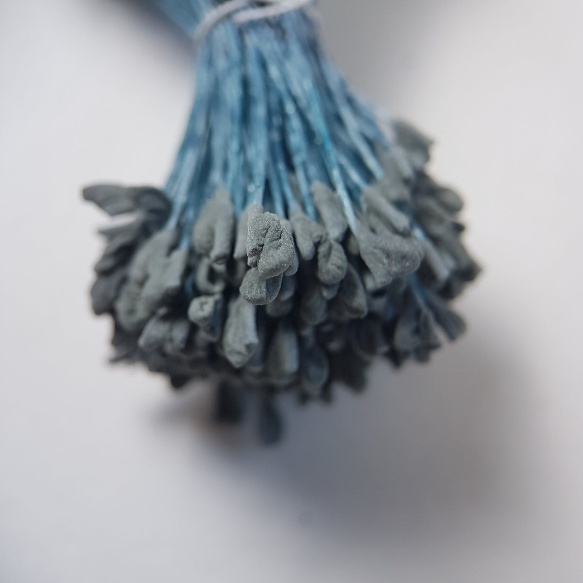 A bundle of extra-large size XL naturalistic Japanese flower stamens, featuring subtle grey droplet-shaped heads on contrasting light blue rayon threads