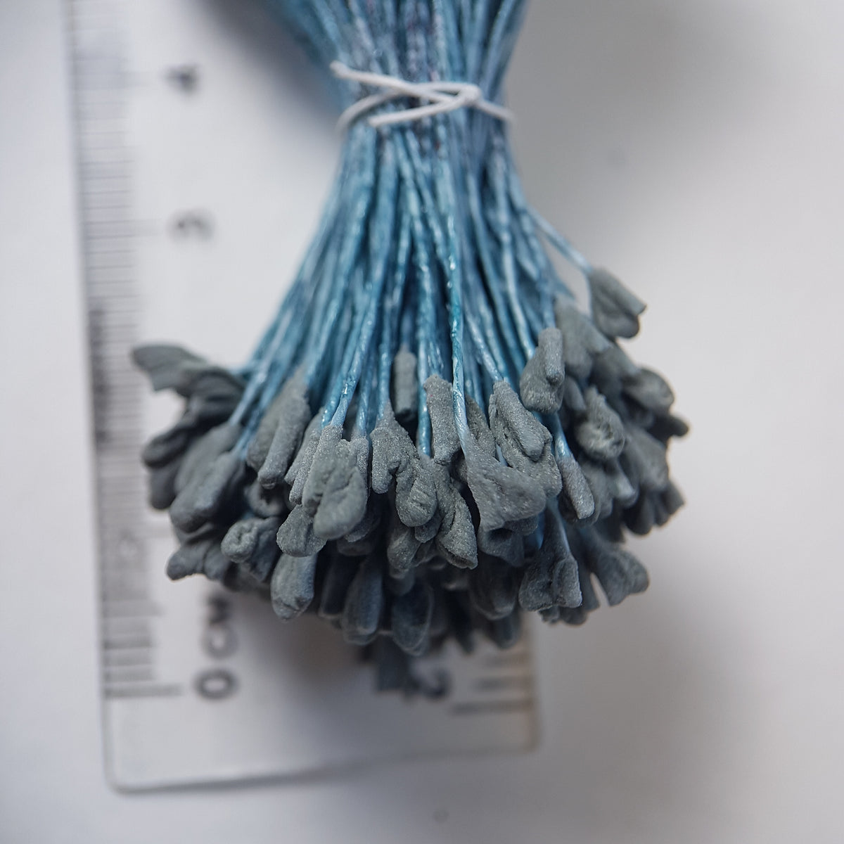 A bundle of extra-large size XL naturalistic Japanese flower stamens, featuring subtle grey droplet-shaped heads on contrasting light blue rayon threads