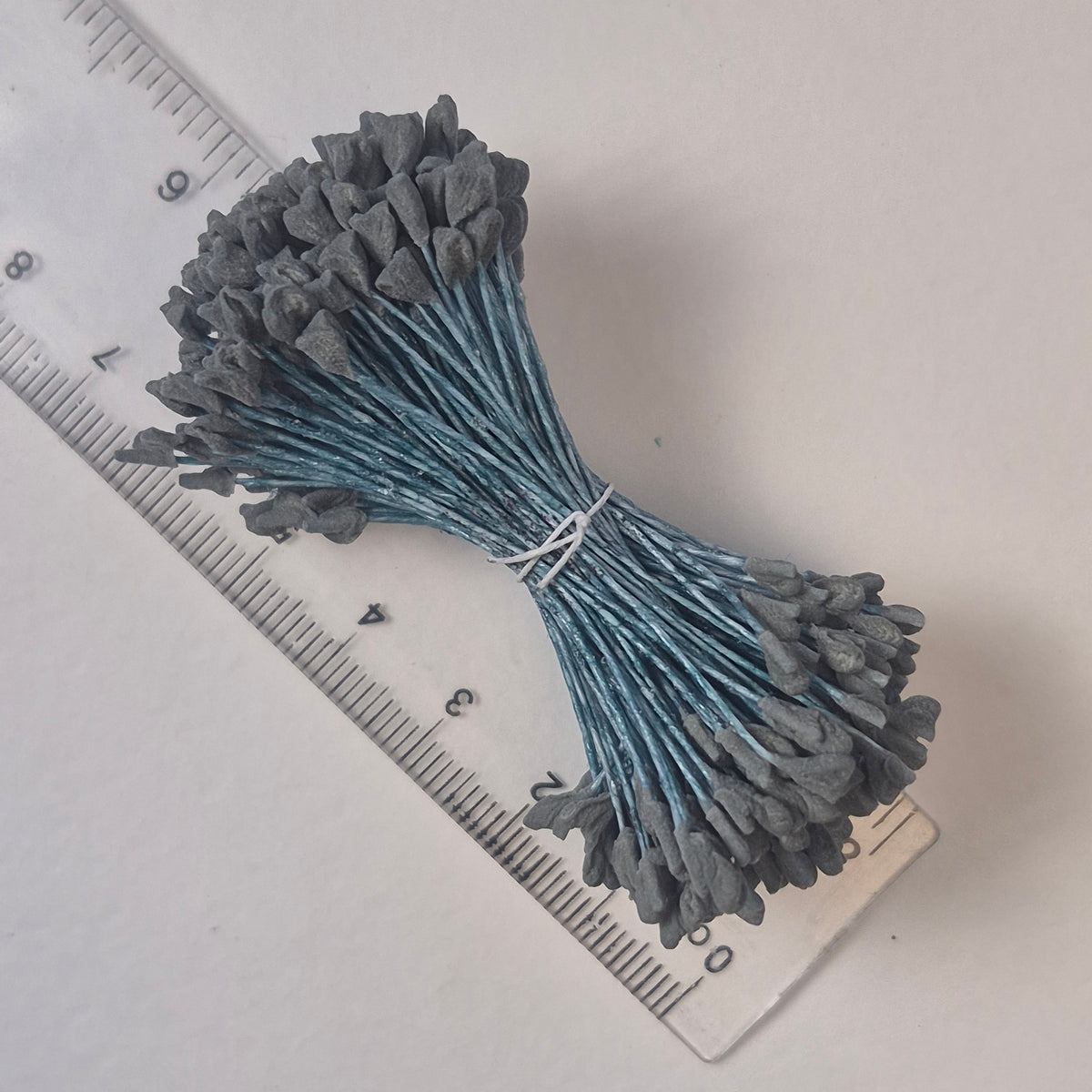 A bundle of extra-large size XL naturalistic Japanese flower stamens, featuring subtle grey droplet-shaped heads on contrasting light blue rayon threads