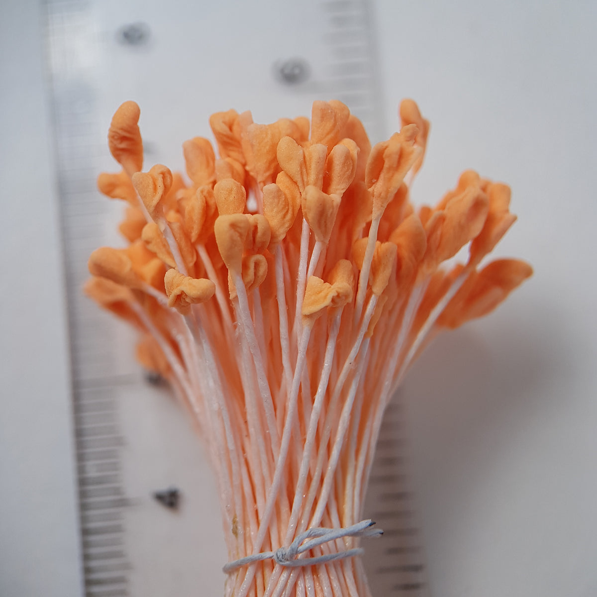 A bundle of extra-large size XL naturalistic Japanese flower stamens, featuring vibrant orange droplet-shaped heads on matching orange rayon threads