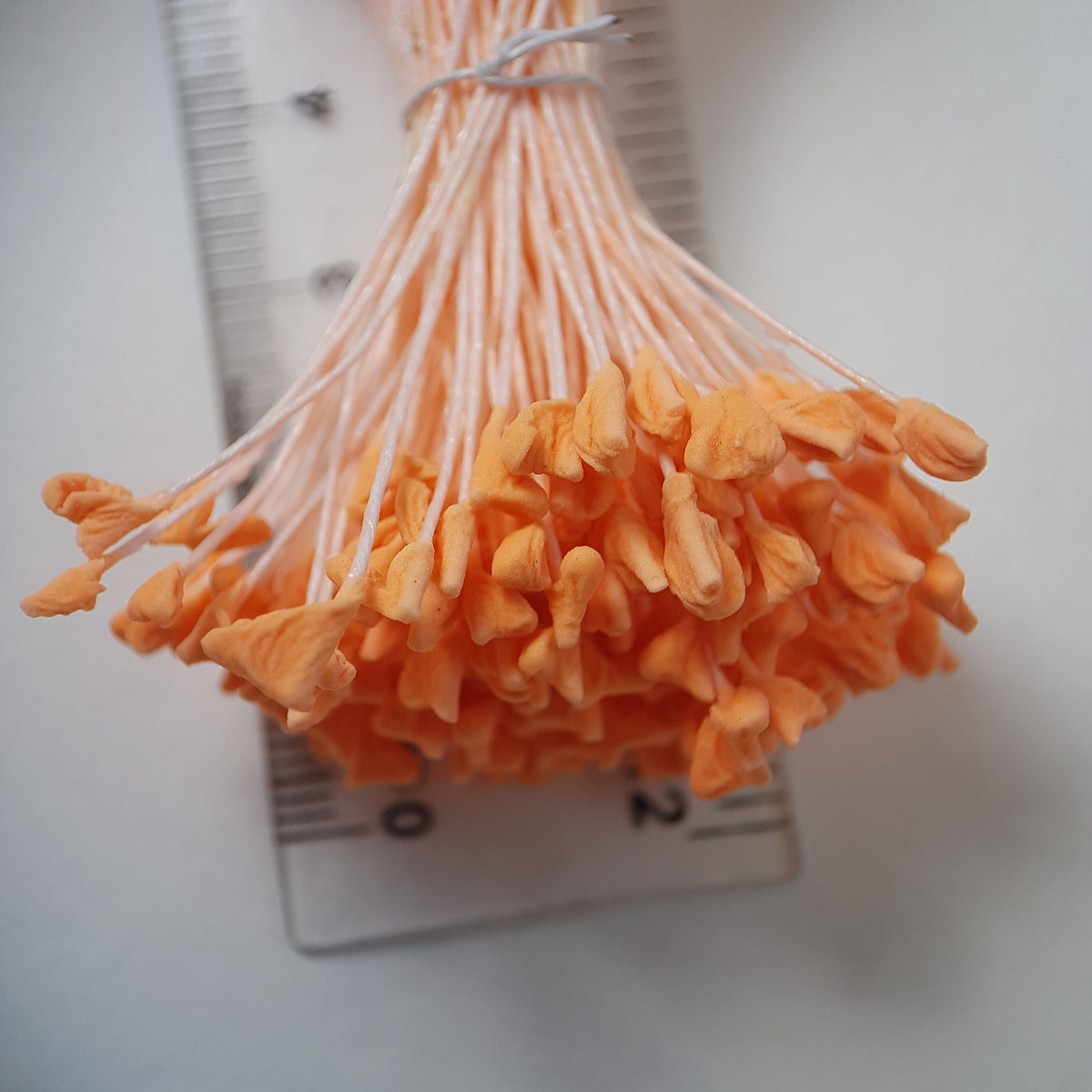 A bundle of extra-large size XL naturalistic Japanese flower stamens, featuring vibrant orange droplet-shaped heads on matching orange rayon threads