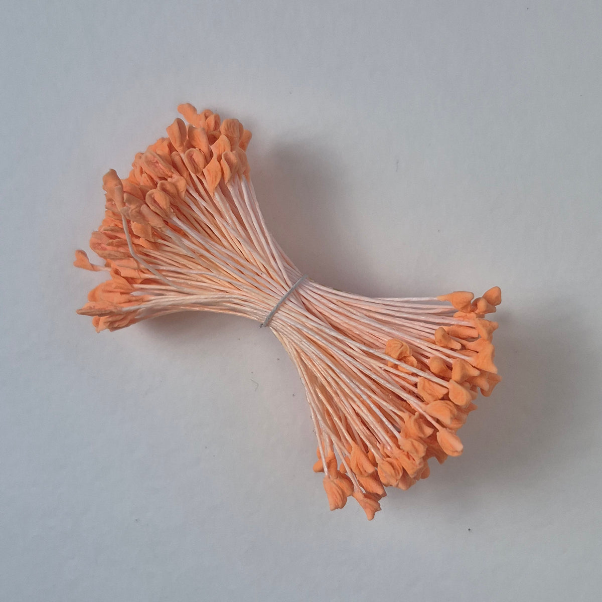 A bundle of extra-large size XL naturalistic Japanese flower stamens, featuring vibrant orange droplet-shaped heads on matching orange rayon threads