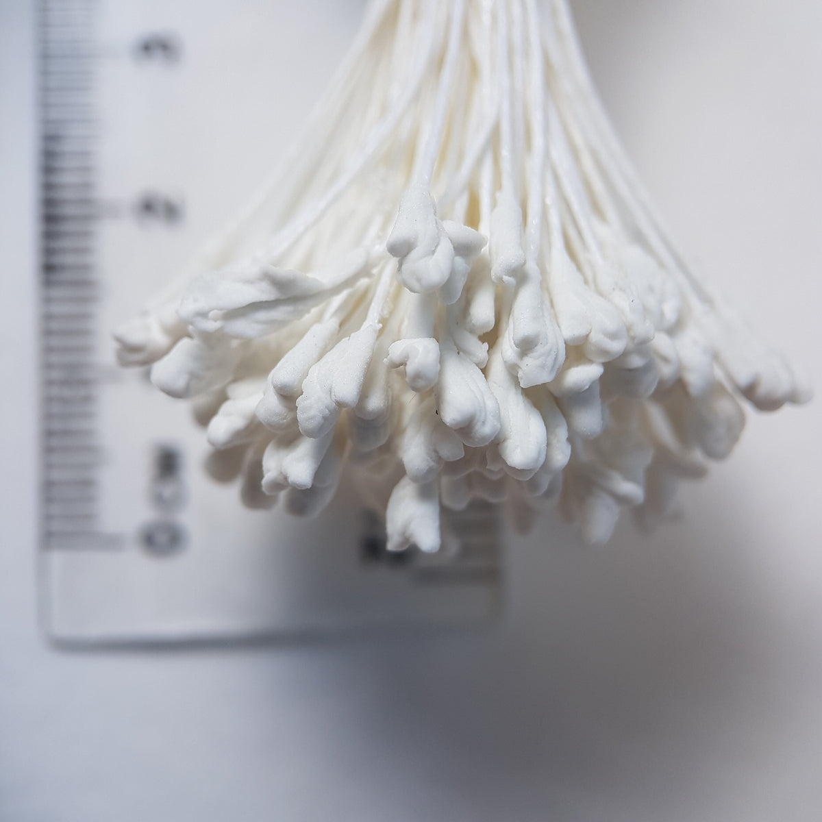 A bundle of extra-large size XL naturalistic Japanese flower stamens, featuring classic white droplet-shaped heads on matching white rayon threads