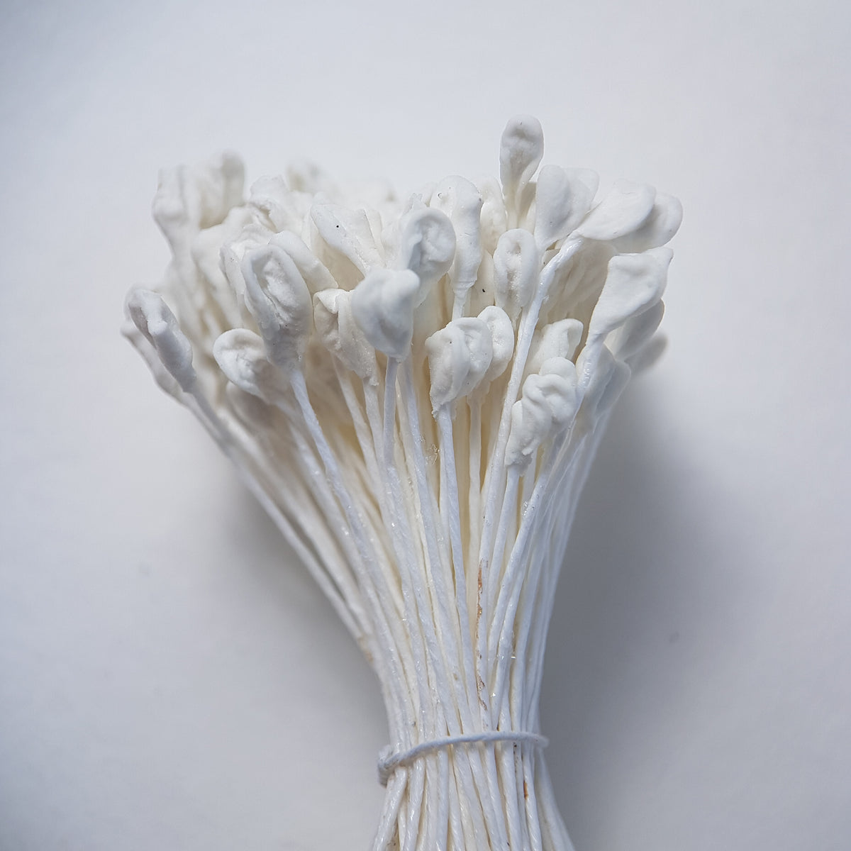 A bundle of extra-large size XL naturalistic Japanese flower stamens, featuring classic white droplet-shaped heads on matching white rayon threads