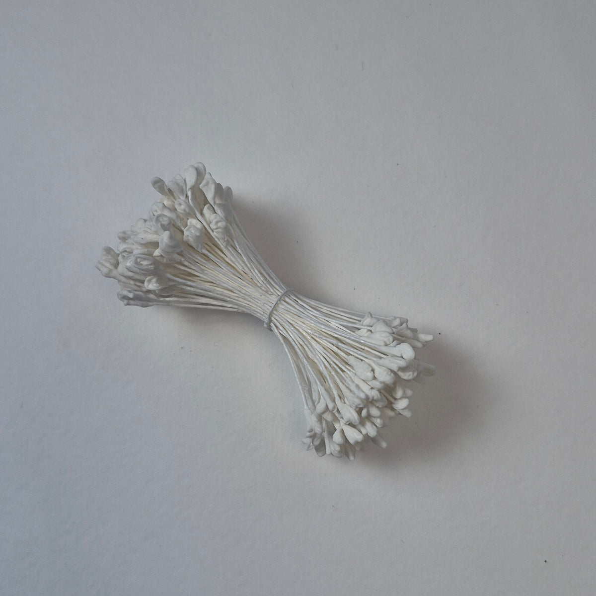 A bundle of extra-large size XL naturalistic Japanese flower stamens, featuring classic white droplet-shaped heads on matching white rayon threads