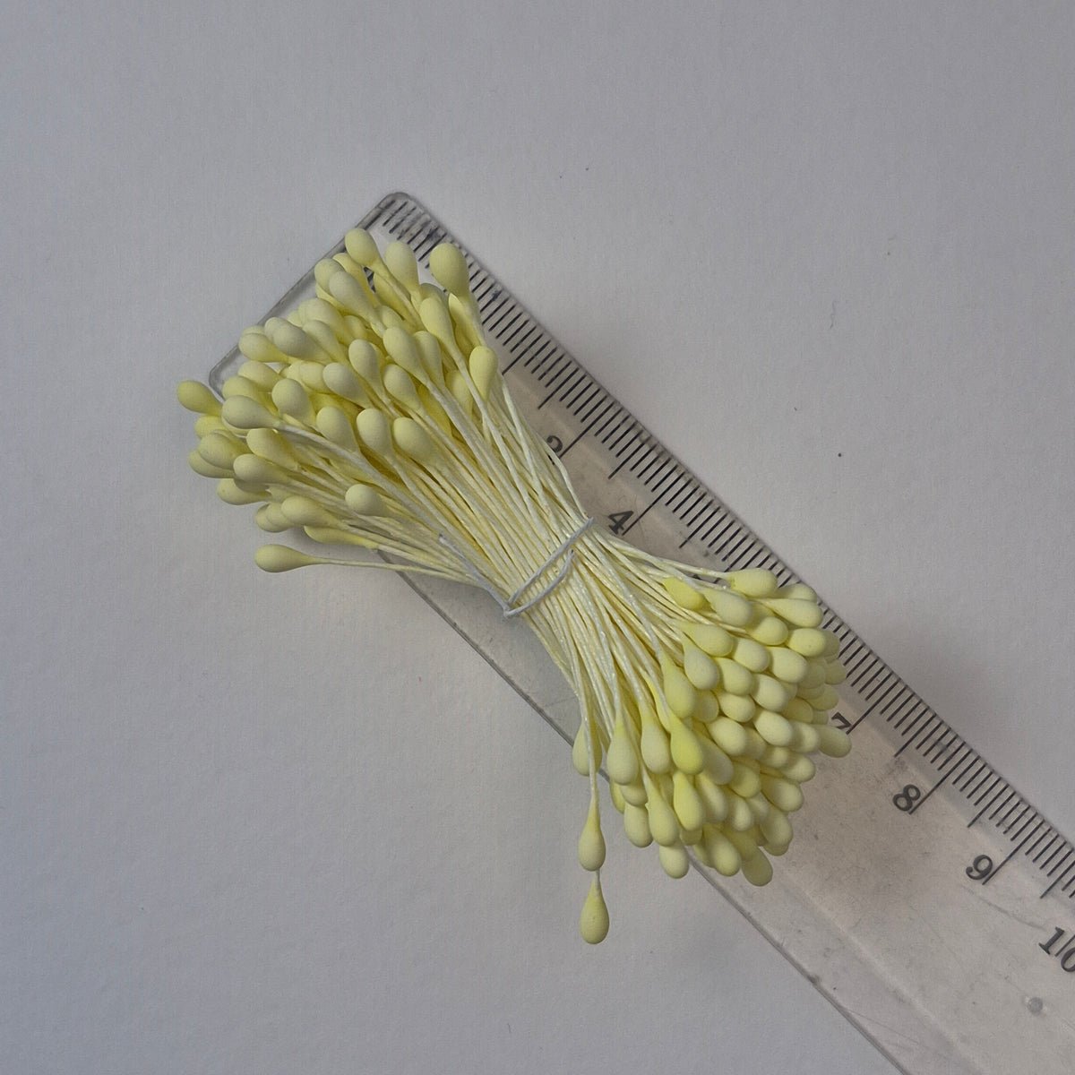 A bundle of size L Japanese flower stamens, featuring vibrant lemon round heads on matching lemon cotton threads