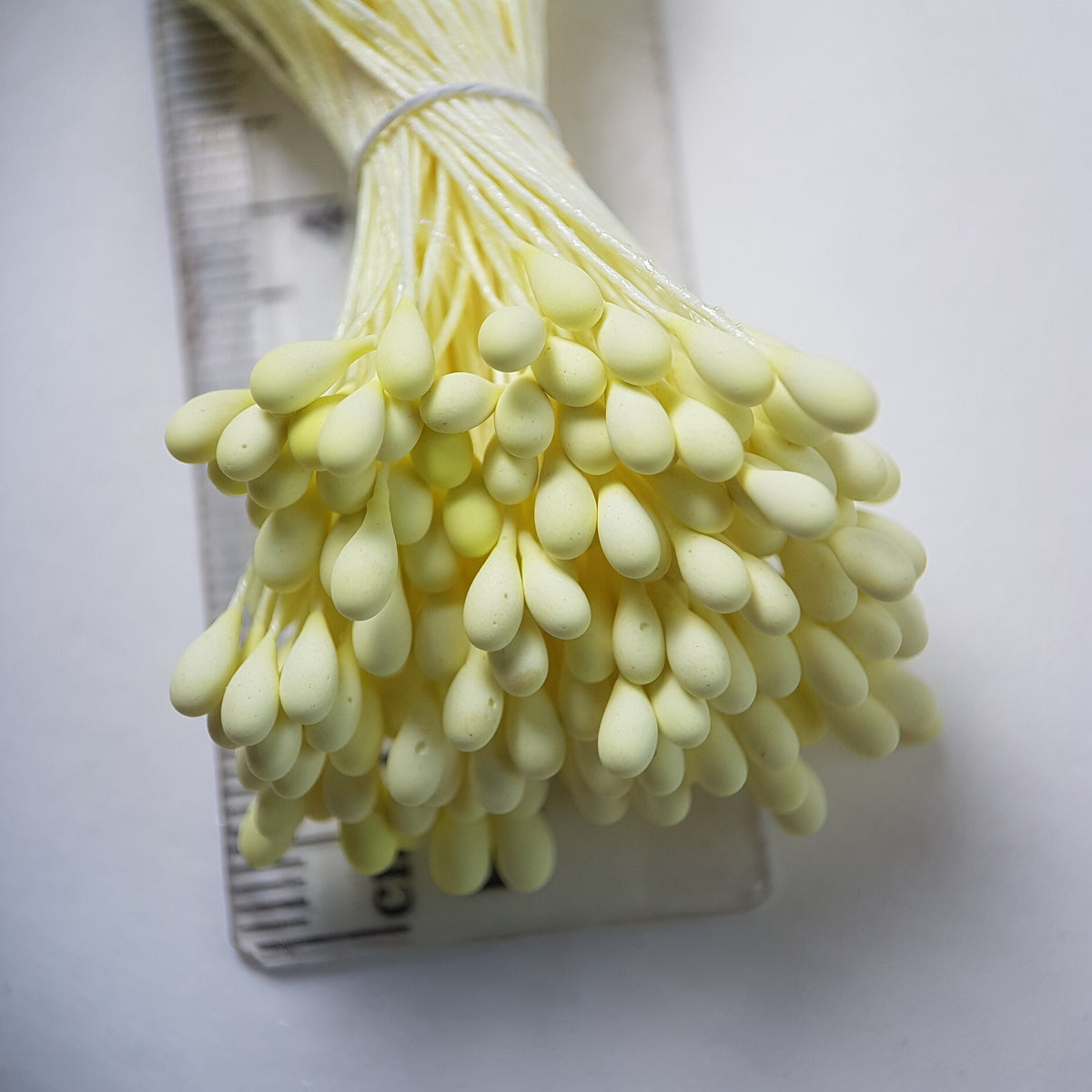 A bundle of size L Japanese flower stamens, featuring vibrant lemon round heads on matching lemon cotton threads