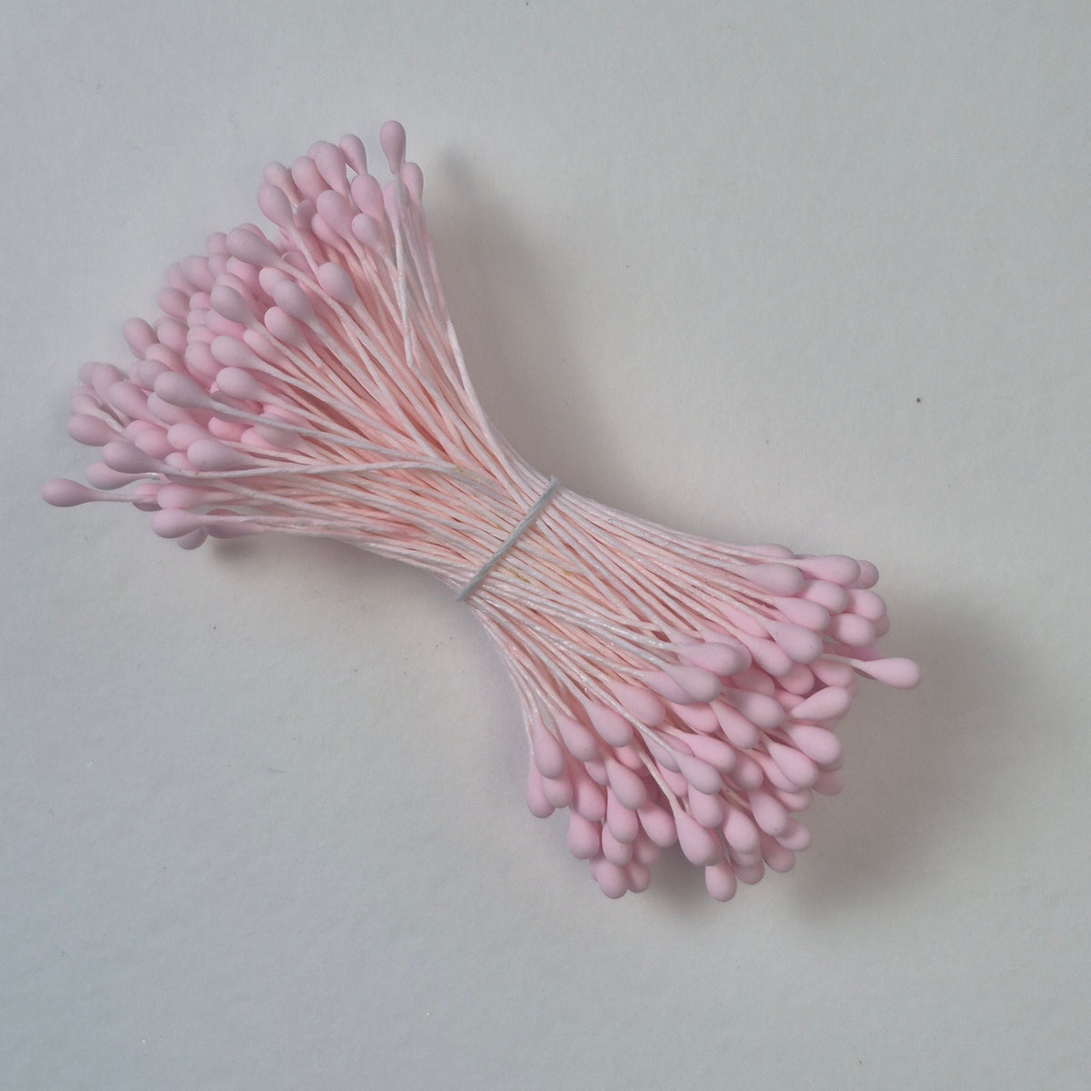 A bundle of size L Japanese flower stamens, featuring vibrant pink droplet-shaped heads on matching pink cotton threads