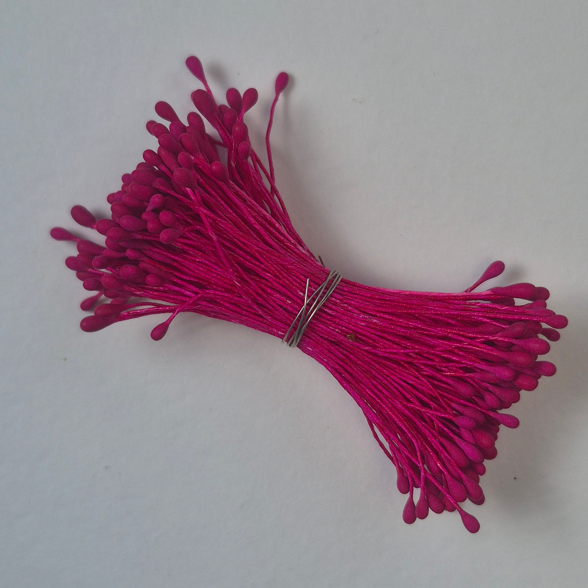 A bundle of size L Japanese flower stamens, featuring vibrant raspberry droplet-shaped heads on matching raspberry cotton threads
