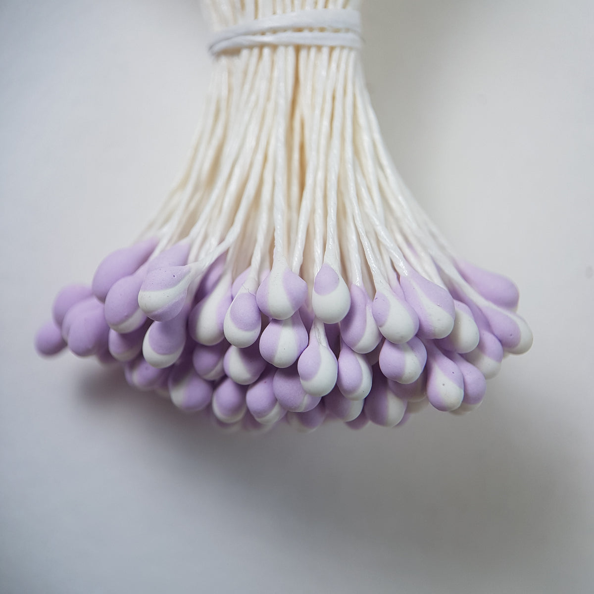 A bundle of extra-large size XL Japanese flower stamens made of rice flour and white rayon threads, featuring unique two-tone lilac and white droplet-shaped heads