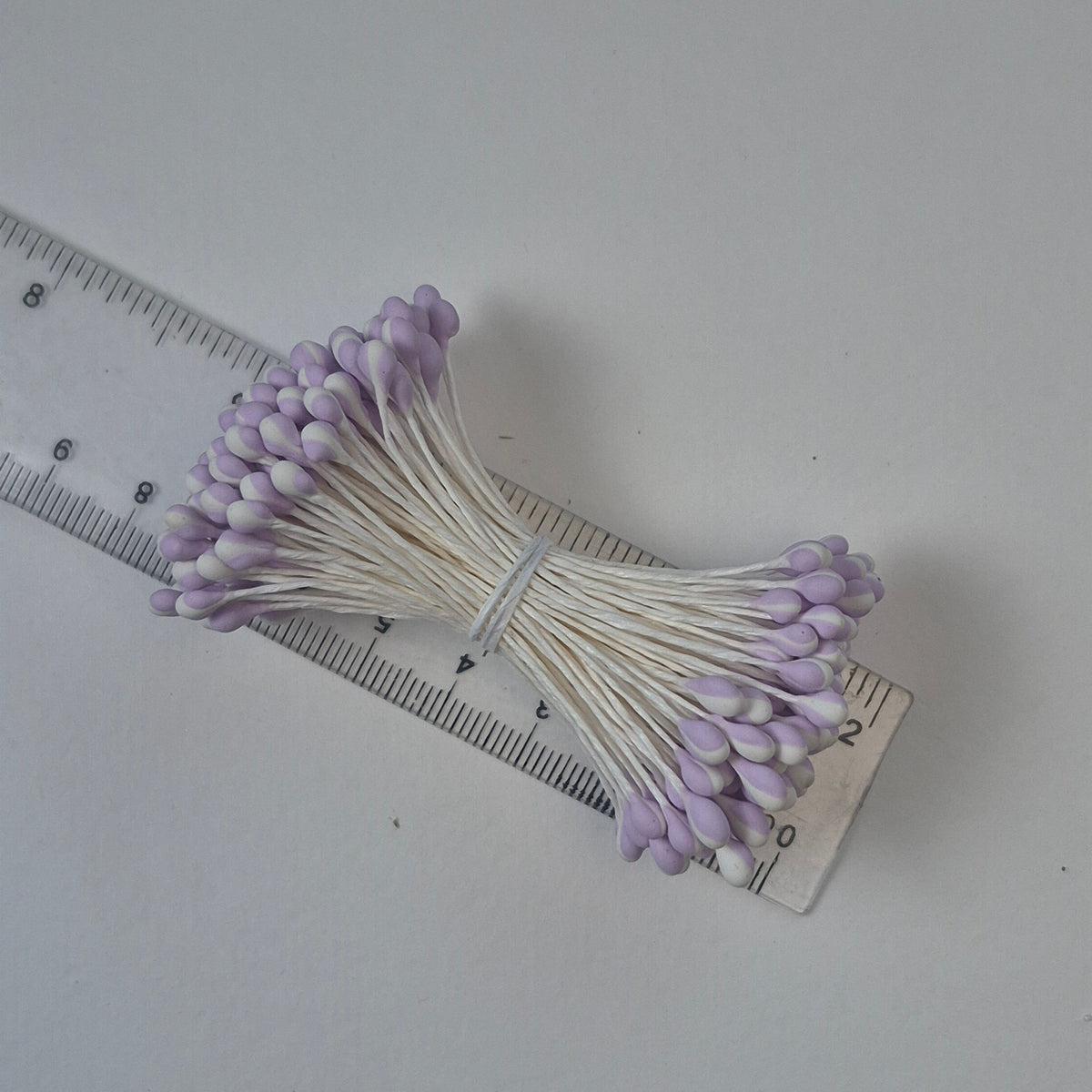 A bundle of extra-large size XL Japanese flower stamens made of rice flour and white rayon threads, featuring unique two-tone lilac and white droplet-shaped heads