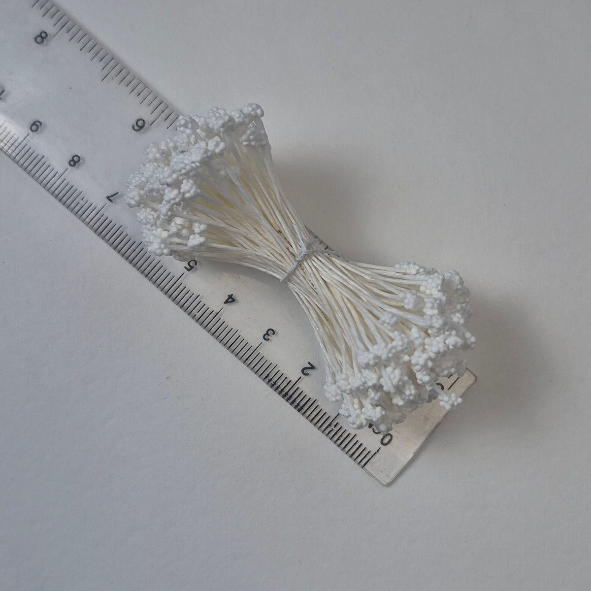 A bundle of extra-large size XL Japanese flower stamens made of rice flour and white rayon threads, featuring pure white textured gypsophila-shaped cluster heads next to a ruler