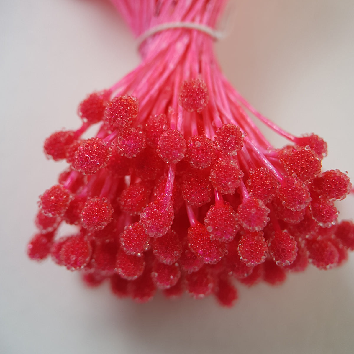 A bundle of size XL Japanese bright pink sugar ball flower stamens made of rice flour and matching pink rayon threads, featuring 5mm frosted textured round heads next to a ruler