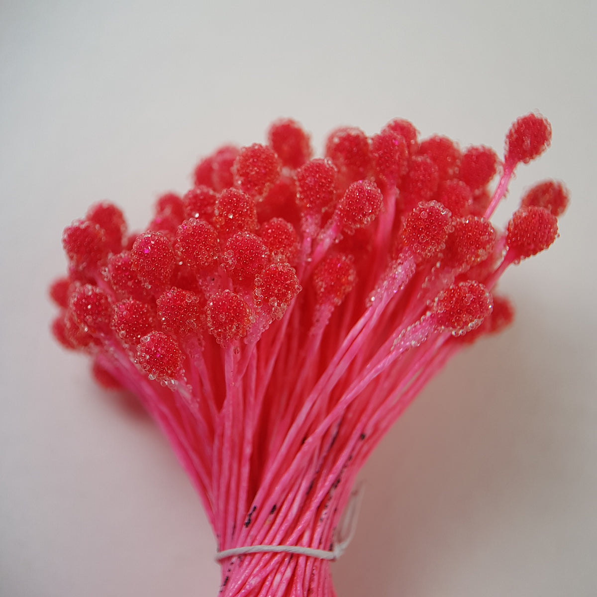 A bundle of size XL Japanese bright pink sugar ball flower stamens made of rice flour and matching pink rayon threads, featuring 5mm frosted textured round heads next to a ruler