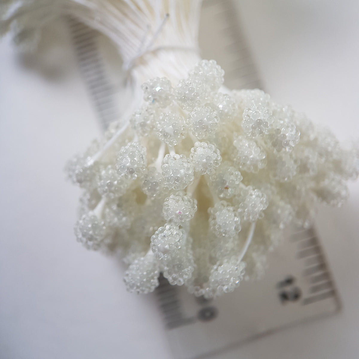 A bundle of size XL Japanese white sugar ball flower stamens made of rice flour and white rayon threads, featuring 5mm frosted round heads