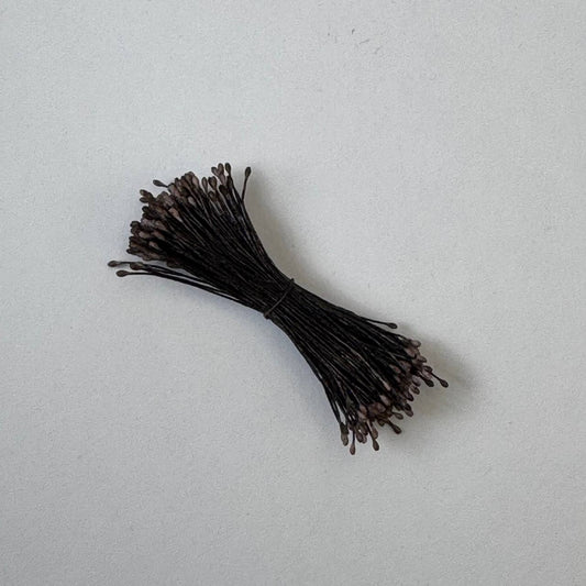 Small bundle of brown round flower stamens on brown cotton thread for silk floristry