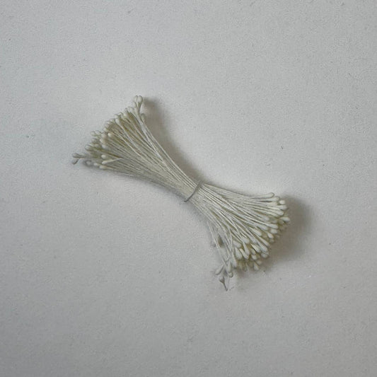 Small bundle of cream round flower stamens on cream cotton thread for silk floristry