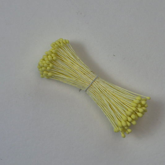 Small bundle of yellow round flower stamens on yellow cotton thread for silk floristry