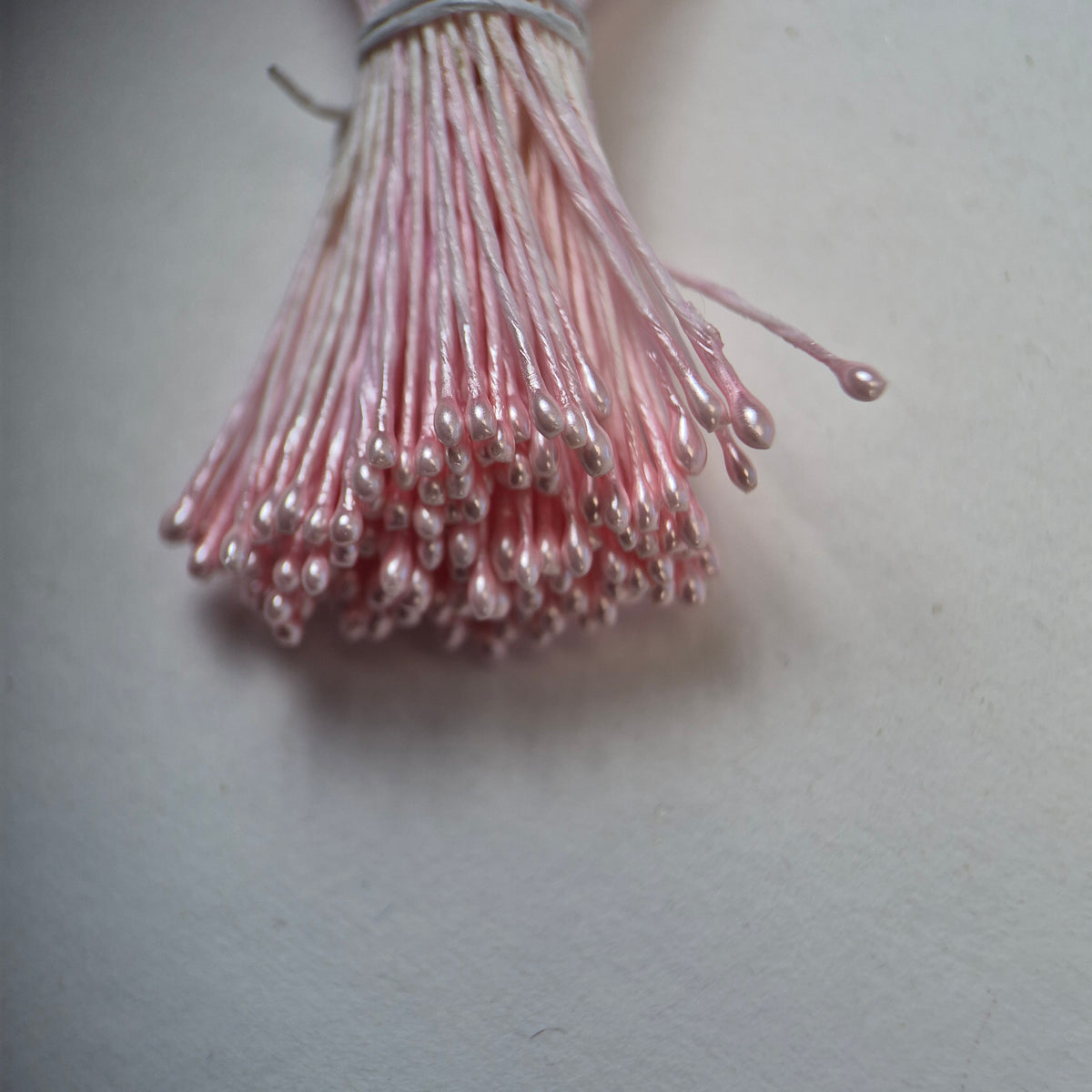 Pink pearly round ball flower stamens size M with glossy luster on matching pink cotton threads, premium Japanese craft supplies