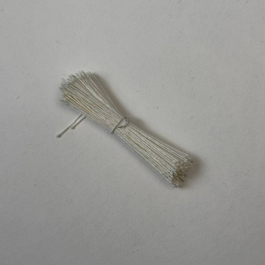 Small bundle of tiny cream round flower stamens on cream cotton thread for silk floristry