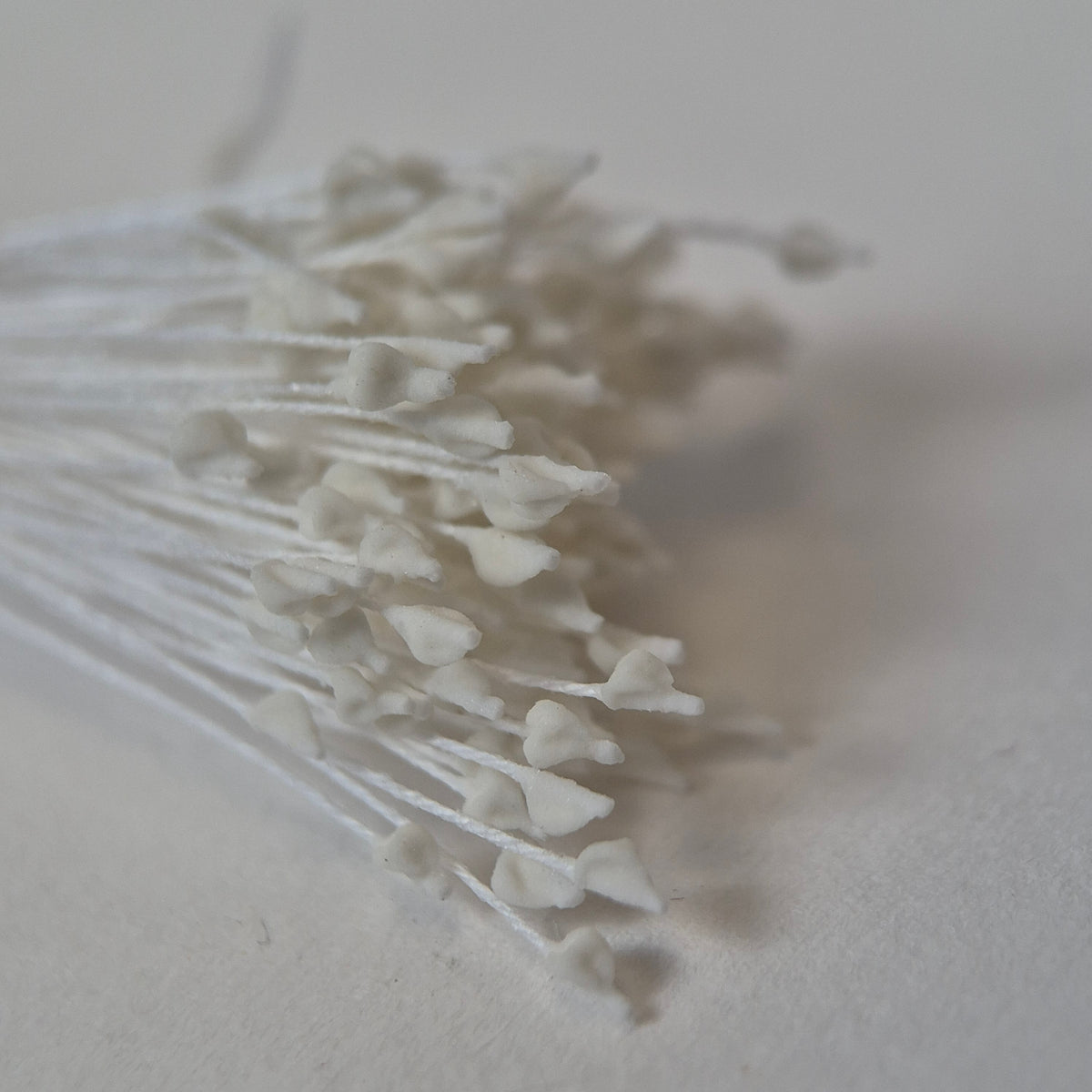 Miniature white naturalistic flower stamens size S with botanical shapes on white cotton threads, premium Japanese craft supplies