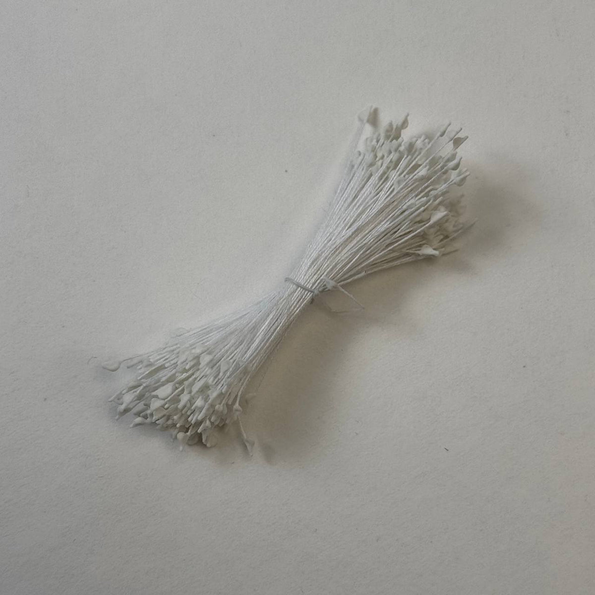 Miniature white naturalistic flower stamens size S with botanical shapes on white cotton threads, premium Japanese craft supplies